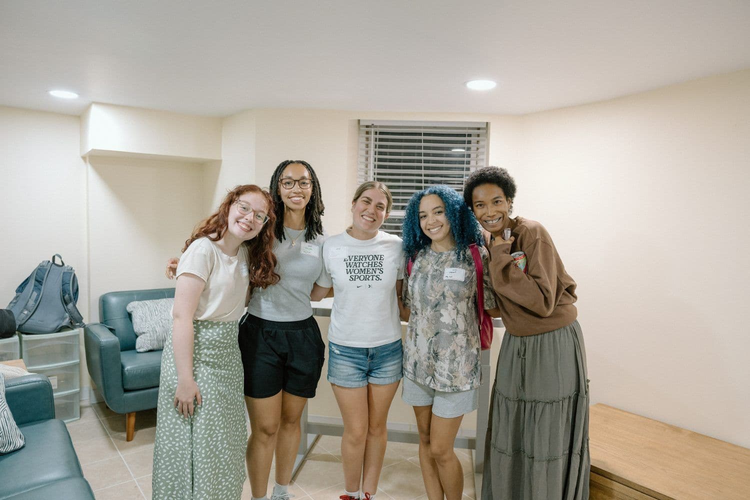 A small group of students sitting together in a living room